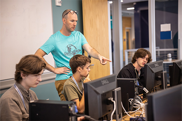 Students learning in a classroom during the GenCyber Camp. 